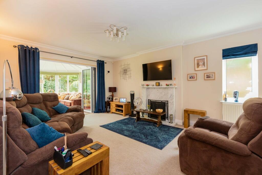 Freshly decorated cream Berkshire living room with white cornice and fireplace, painting and decorating craftsmanship